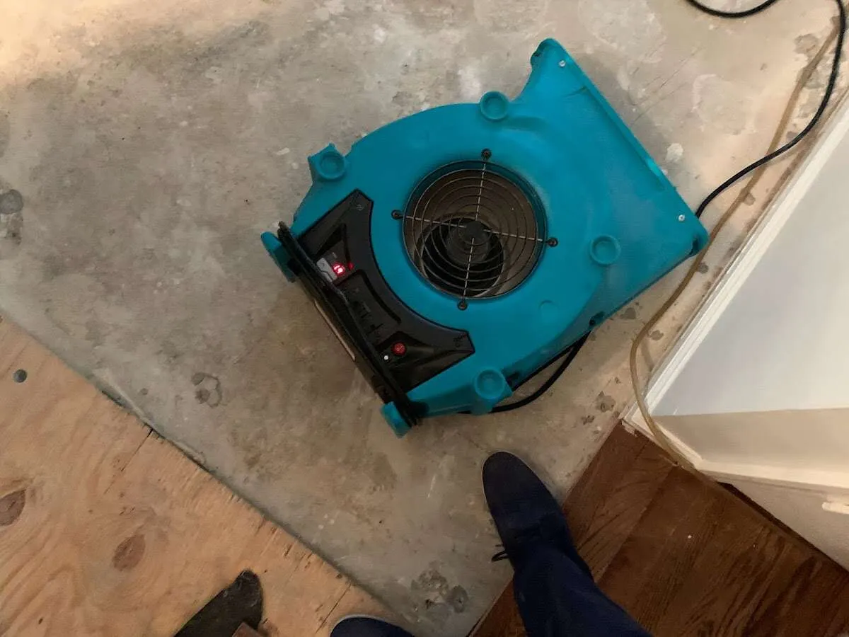 Air mover drying subfloor during Leak Detection & Repair in Conyers